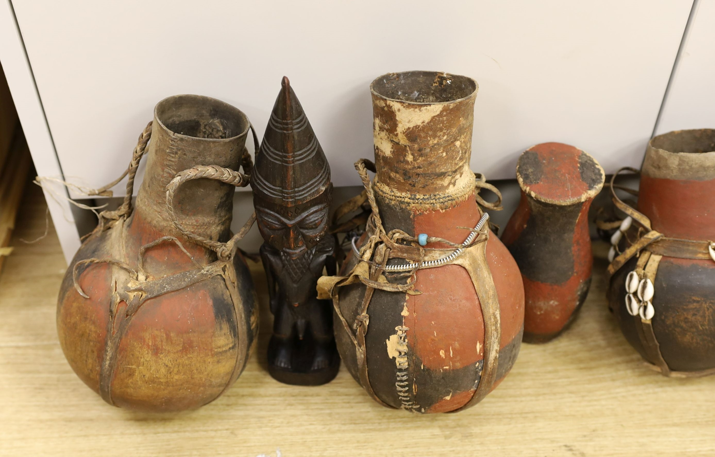 A large quantity of African wood carvings, gourd water carriers, etc.